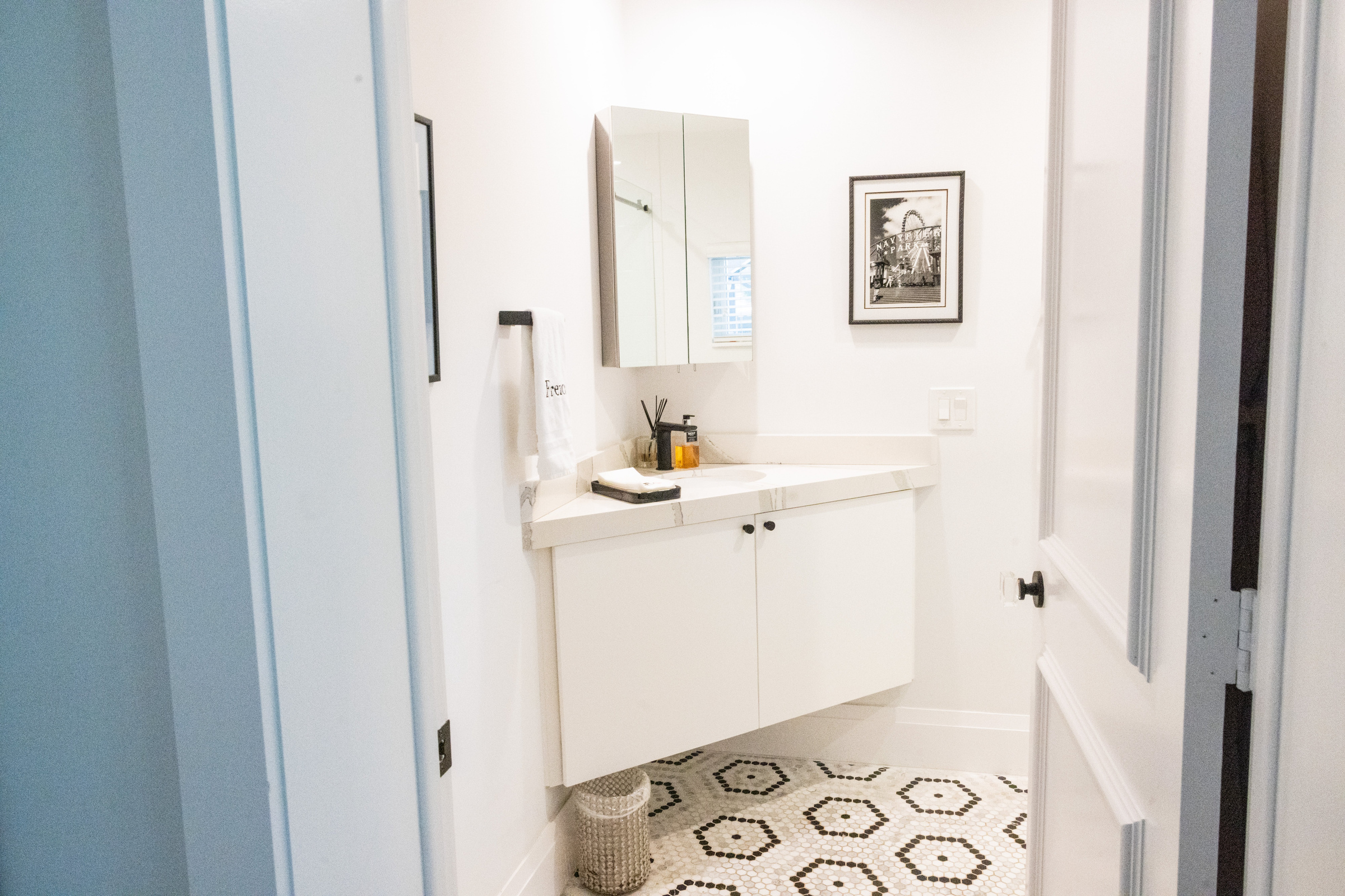 Clean all-white double vanity guest bath with chrome fixtures