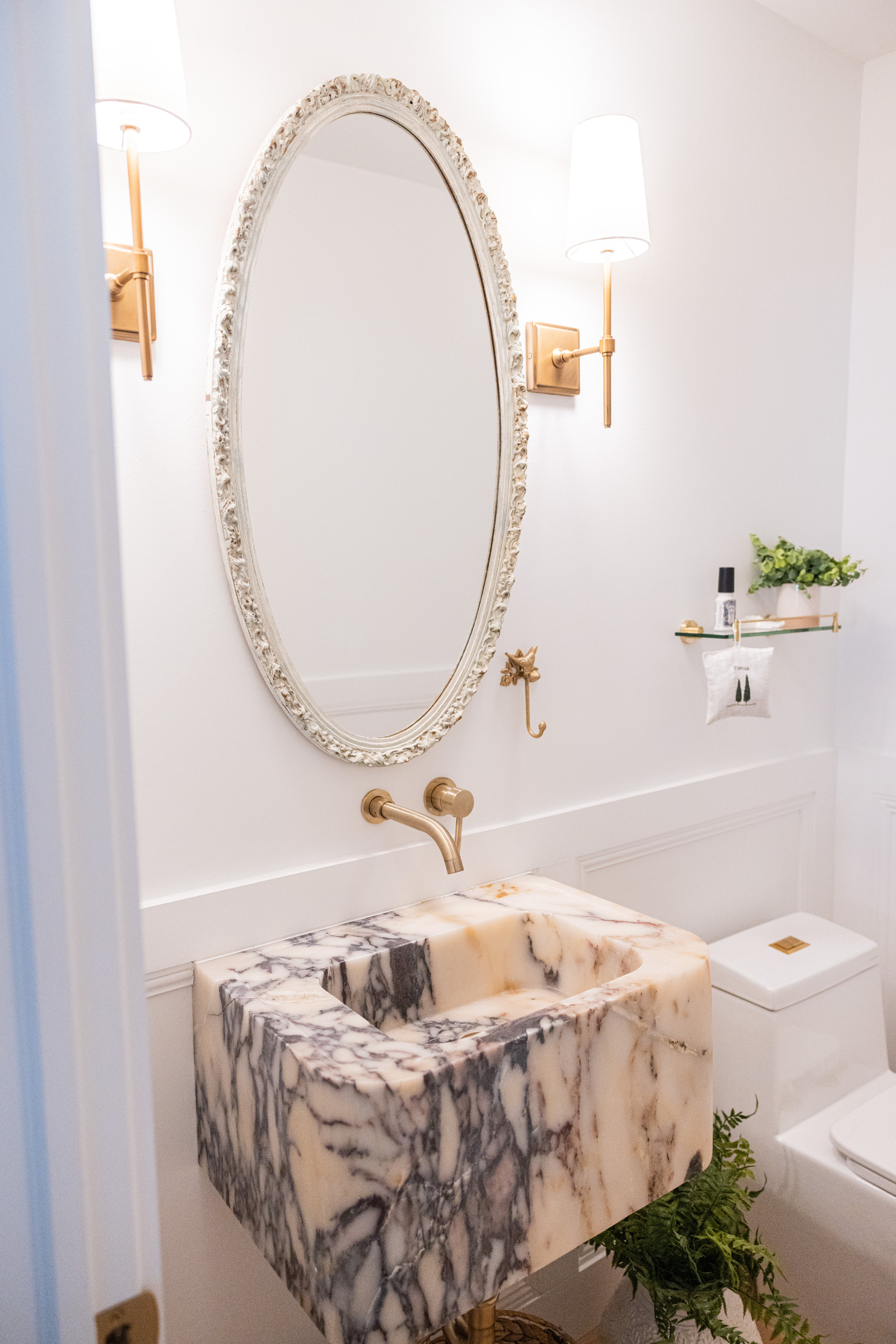 Vibrant guest bath with colorful monkey wallpaper and rattan mirror