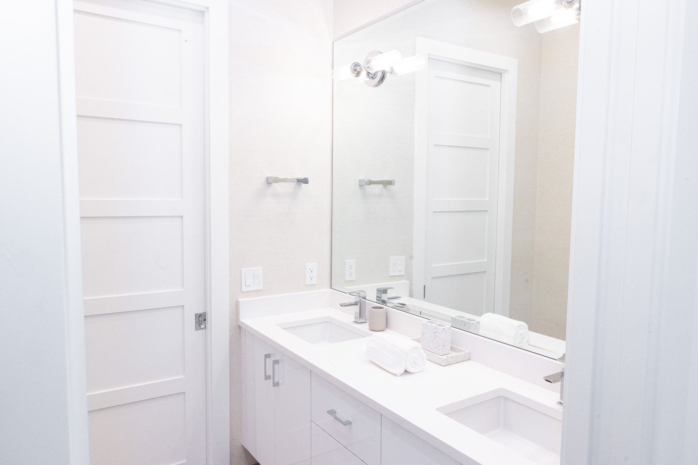 Navy blue bathroom with bold art and wall-hung toilet