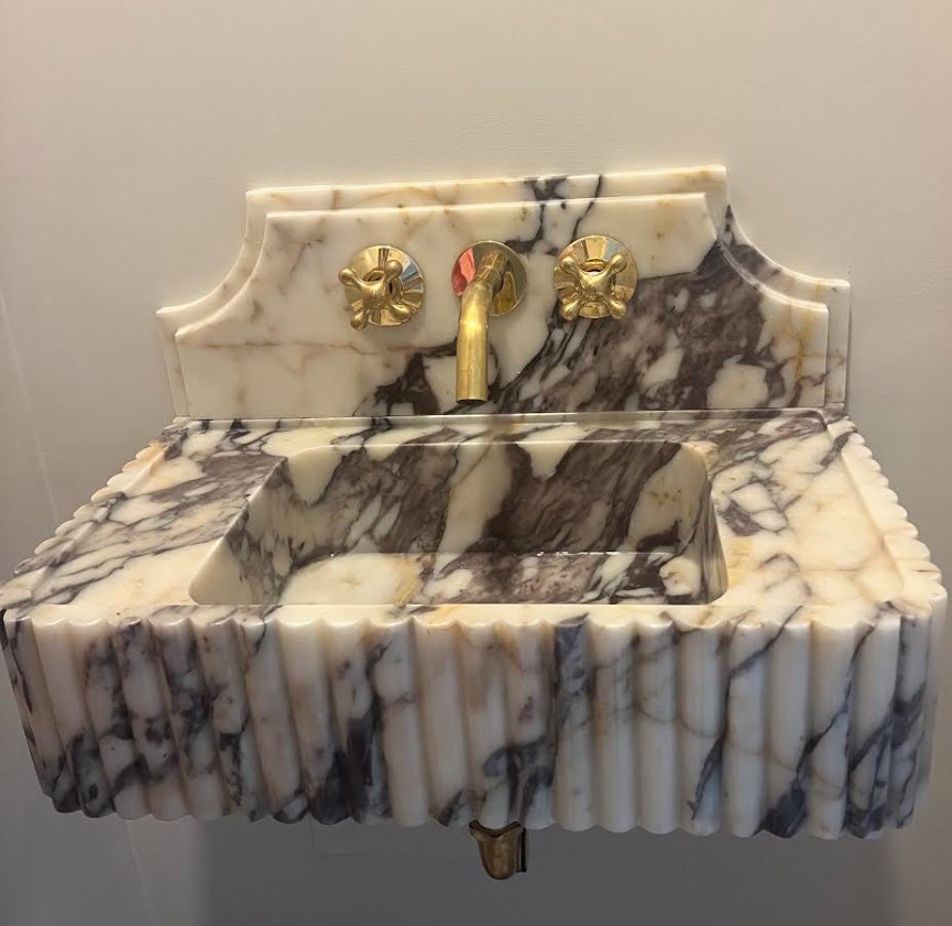 Antique fluted marble vanity sink with brass cross-handle fixtures