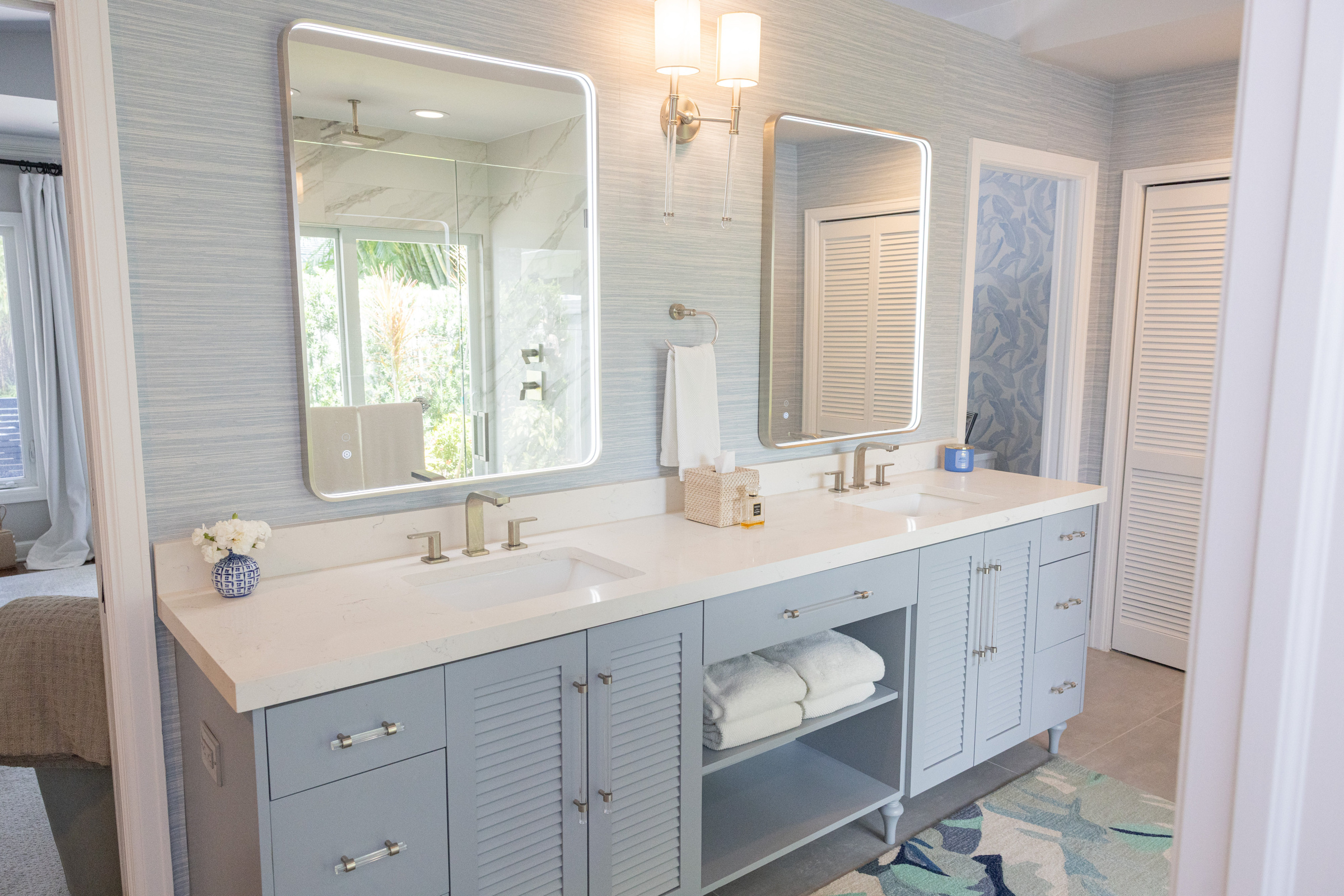 Master bath blue-gray vanity with grasscloth wallpaper and LED mirrors
