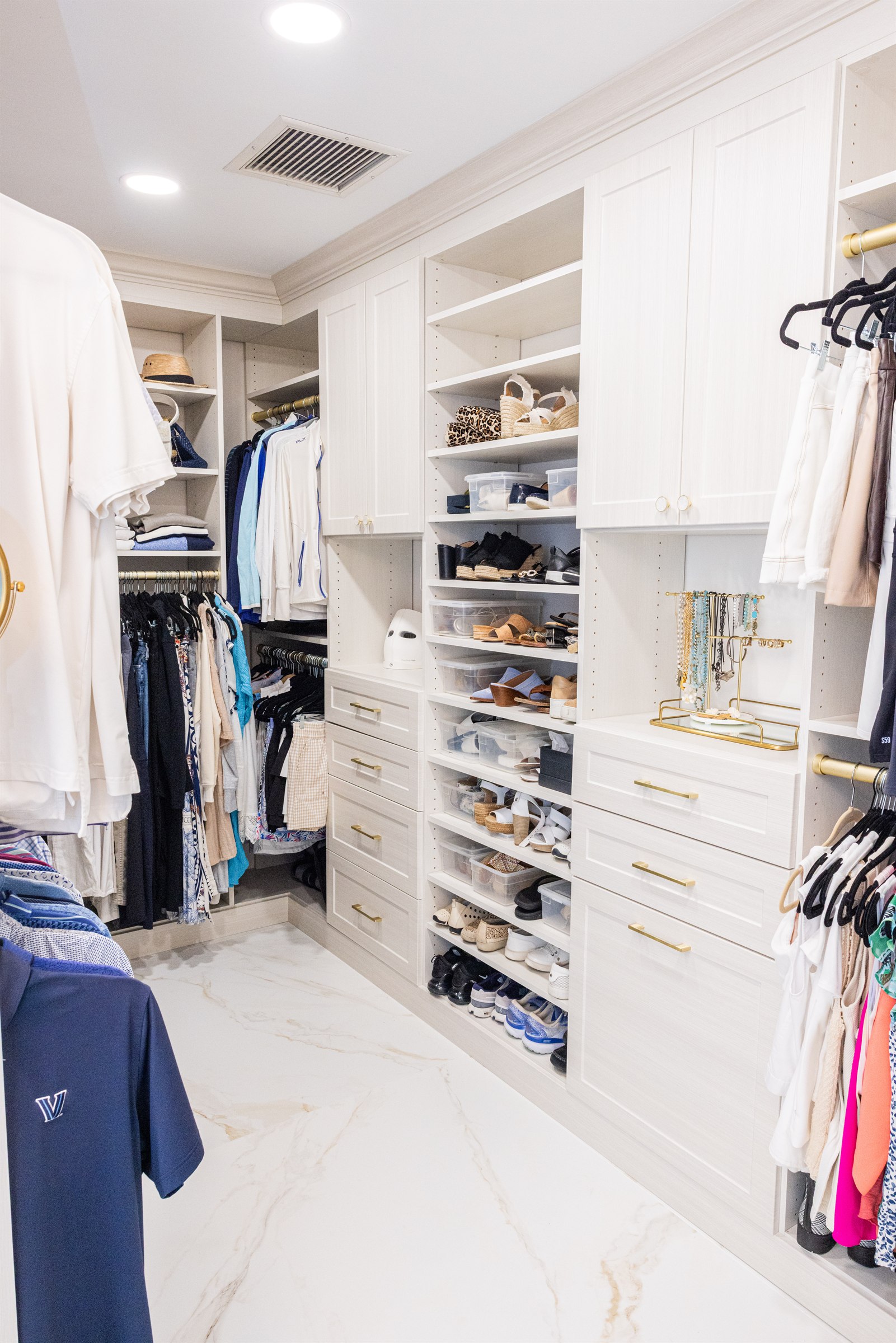Closet detail with shoe shelving, storage drawers, and a jewelry organizer
