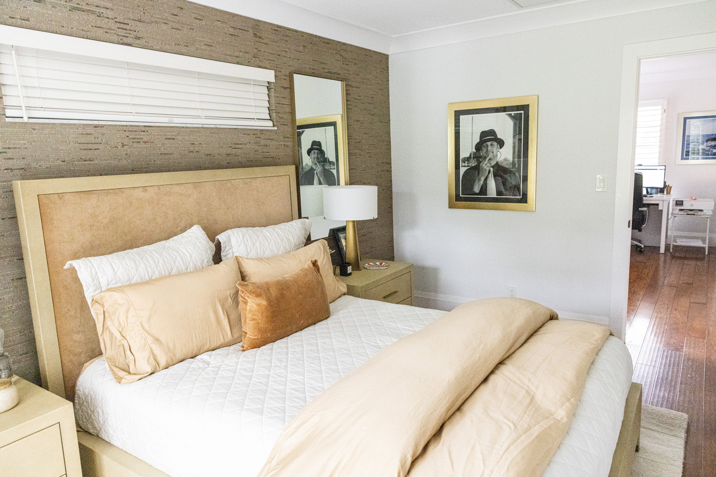 Guest bedroom with floral upholstered headboard in green and navy accents