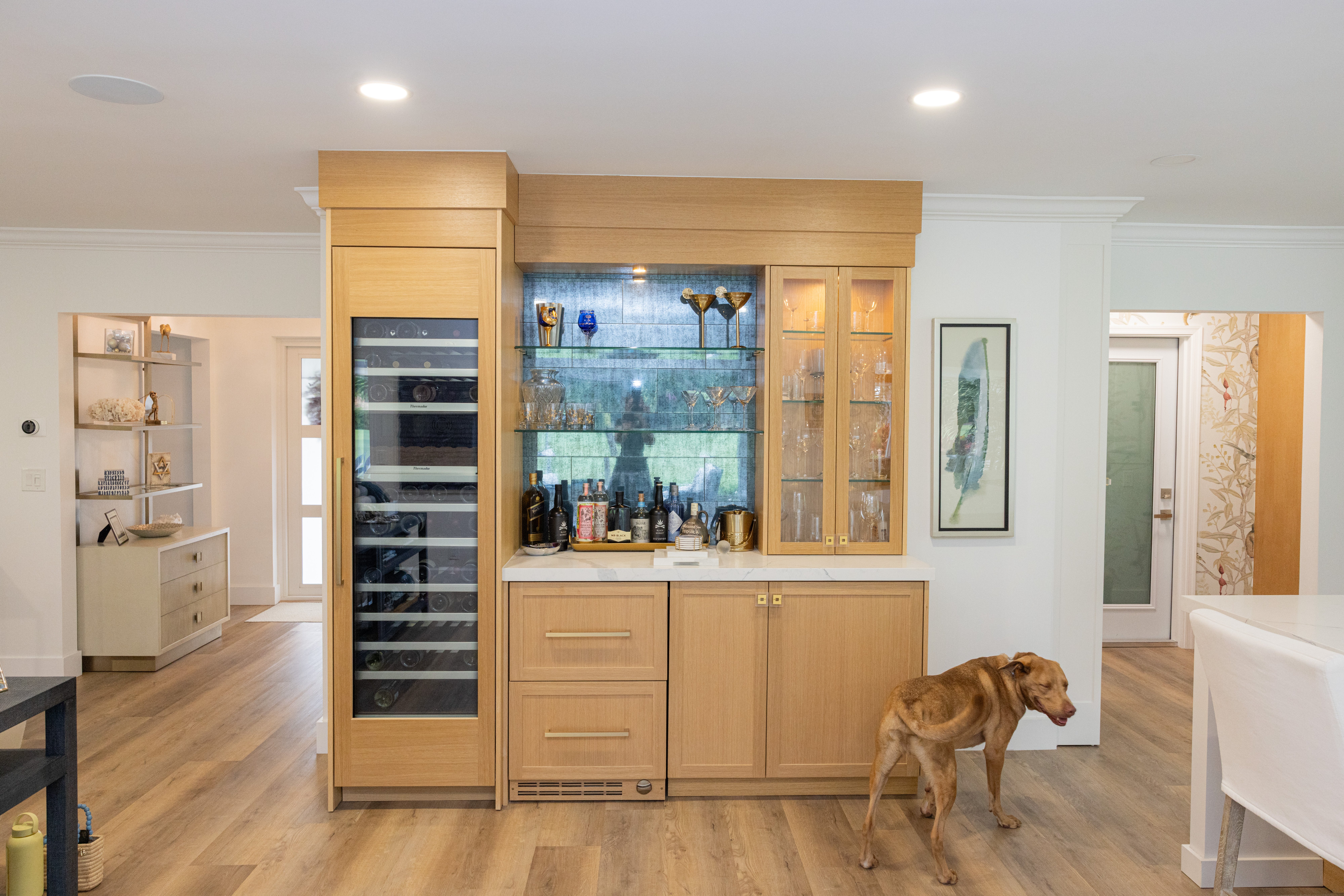 Natural oak kitchen bar with wine fridge and illuminated glass shelving