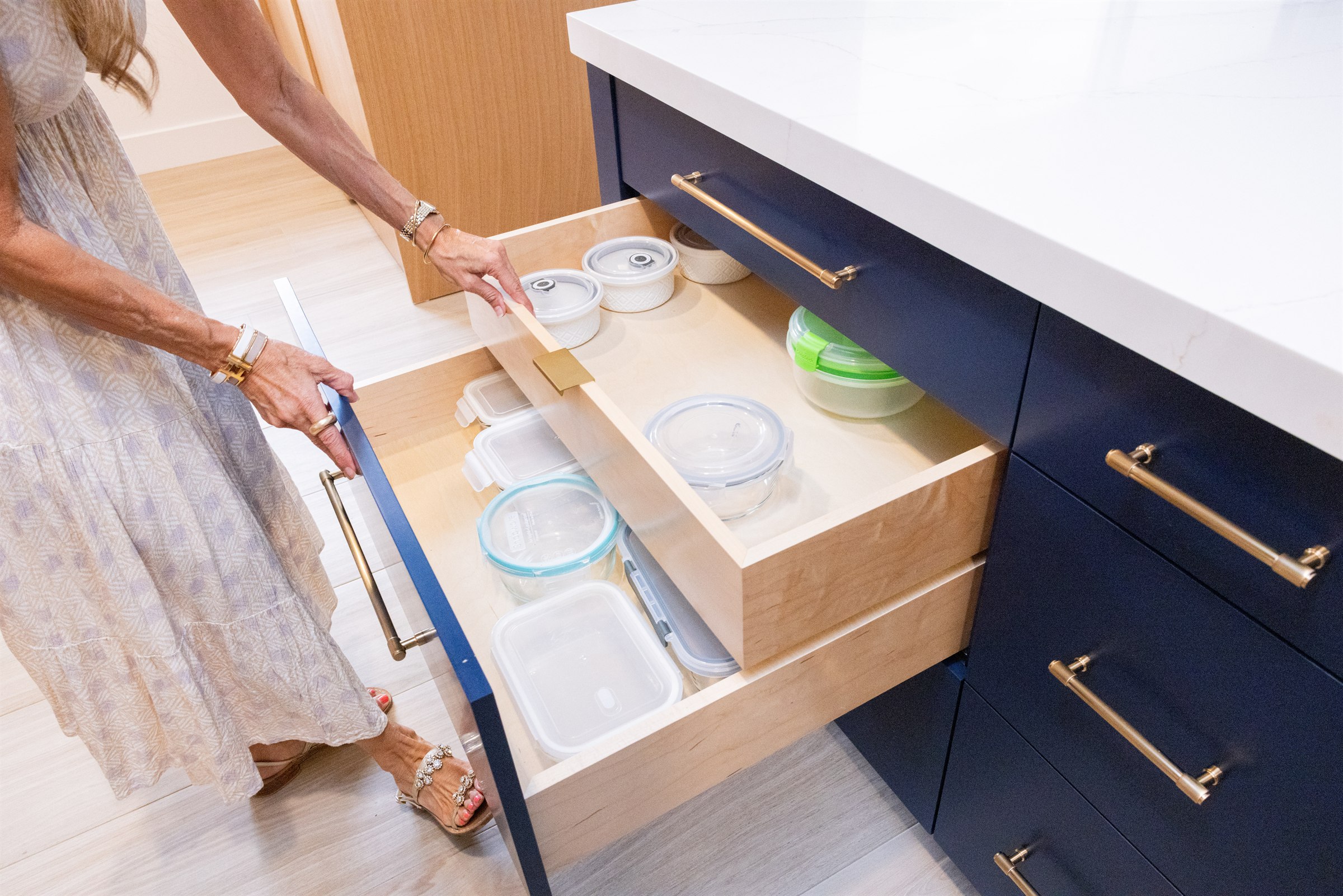 Navy island drawer pulled open revealing stacked food storage containers