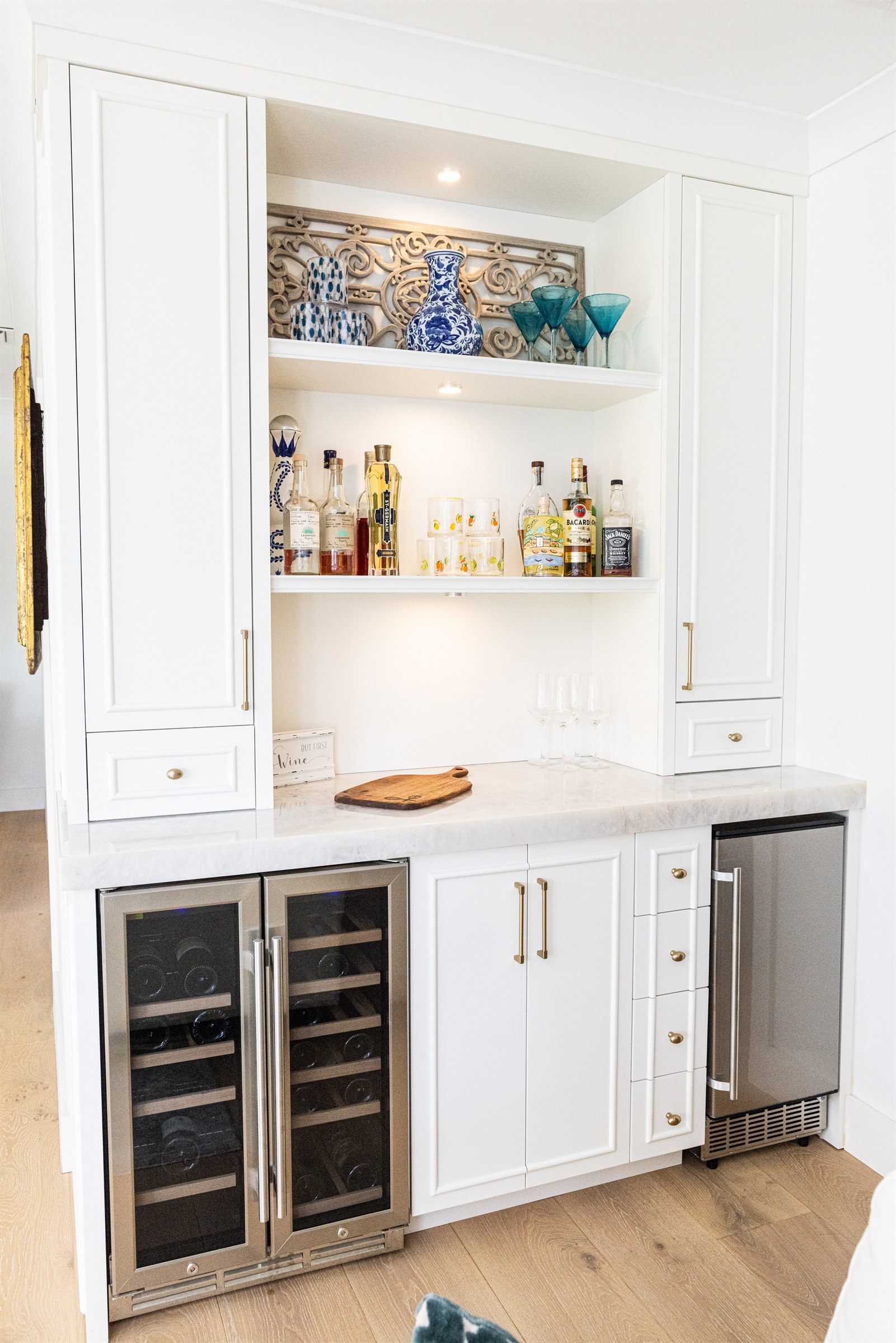 Wet bar nook, wider view showing both wine cooler doors and glass-front cabinets
