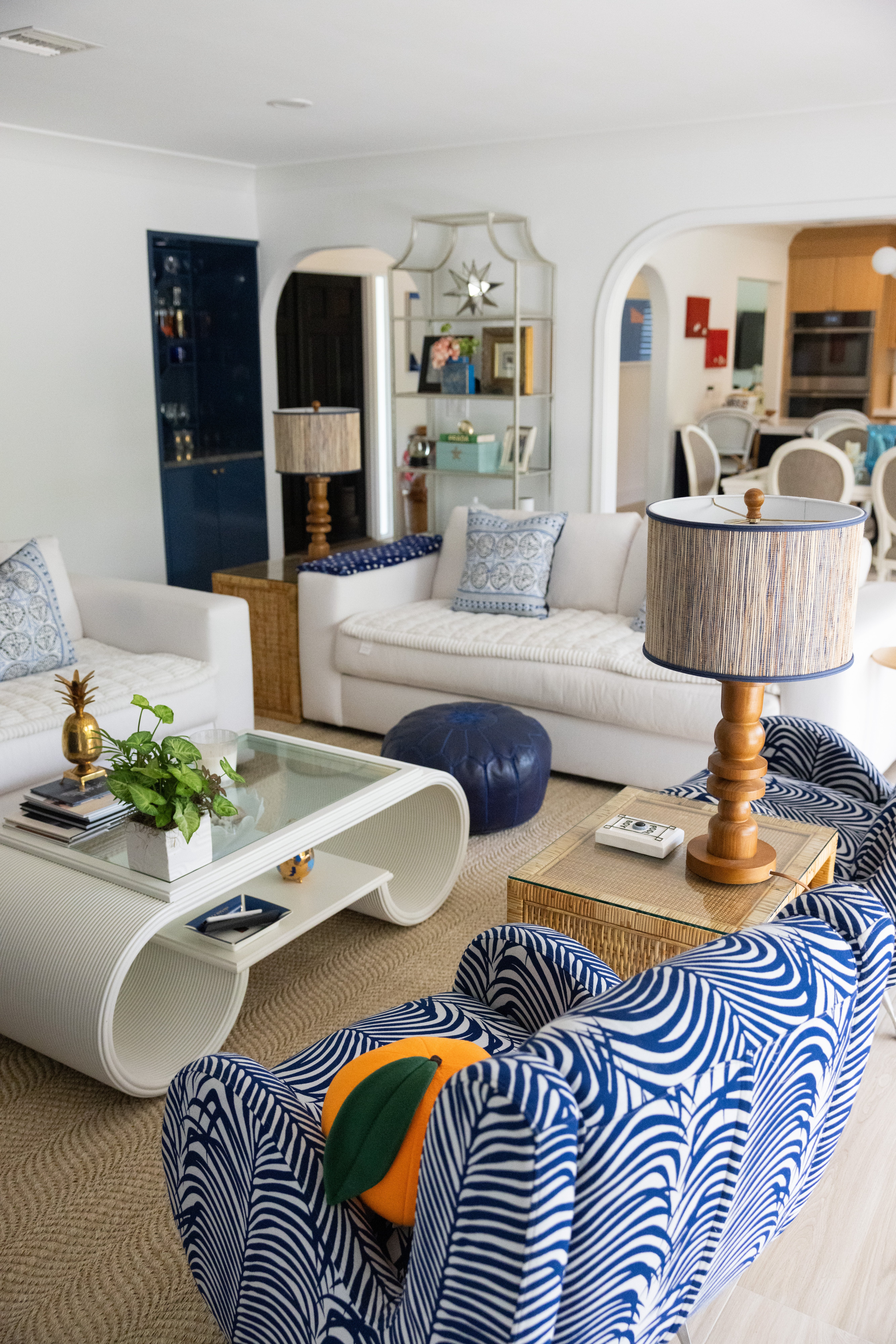 Open-plan living room with bold blue abstract art and white cloud sectional